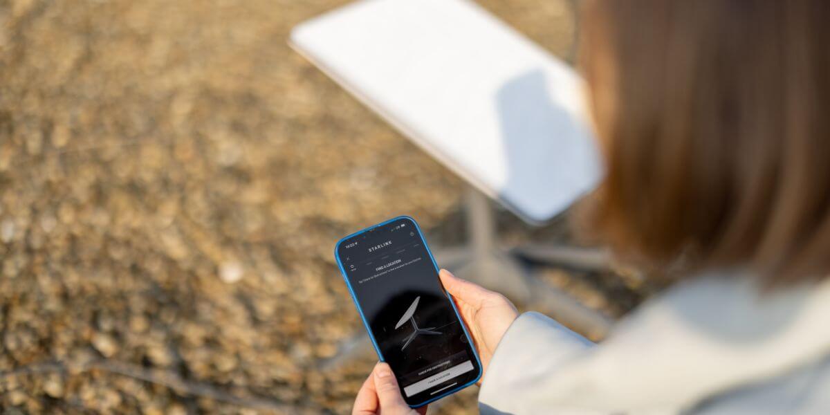 person using phone with starlink satellite
