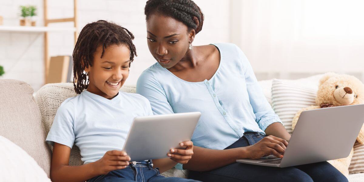 family on couch with devices