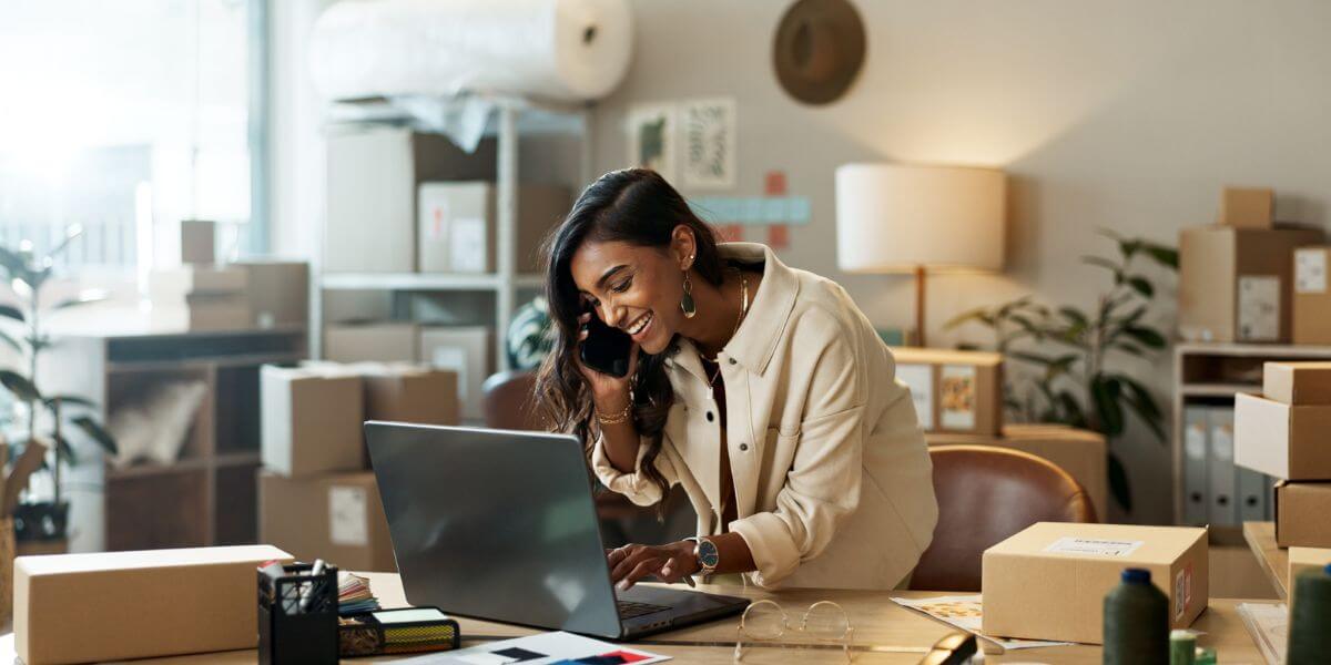 woman using laptop on phone