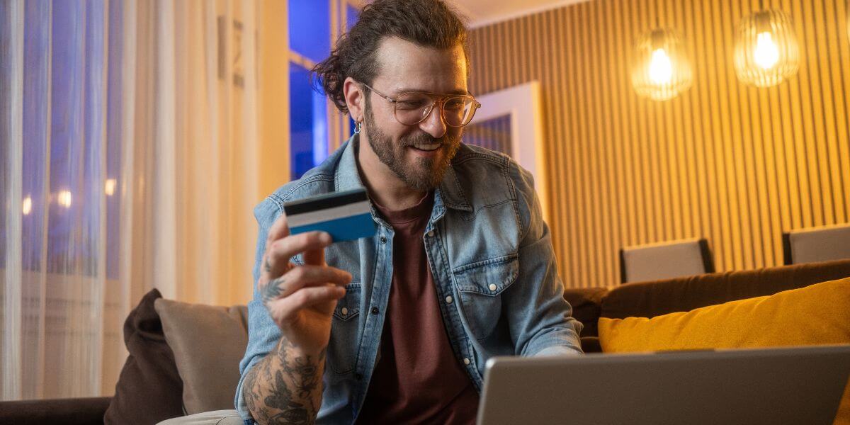 man using credit card and laptop
