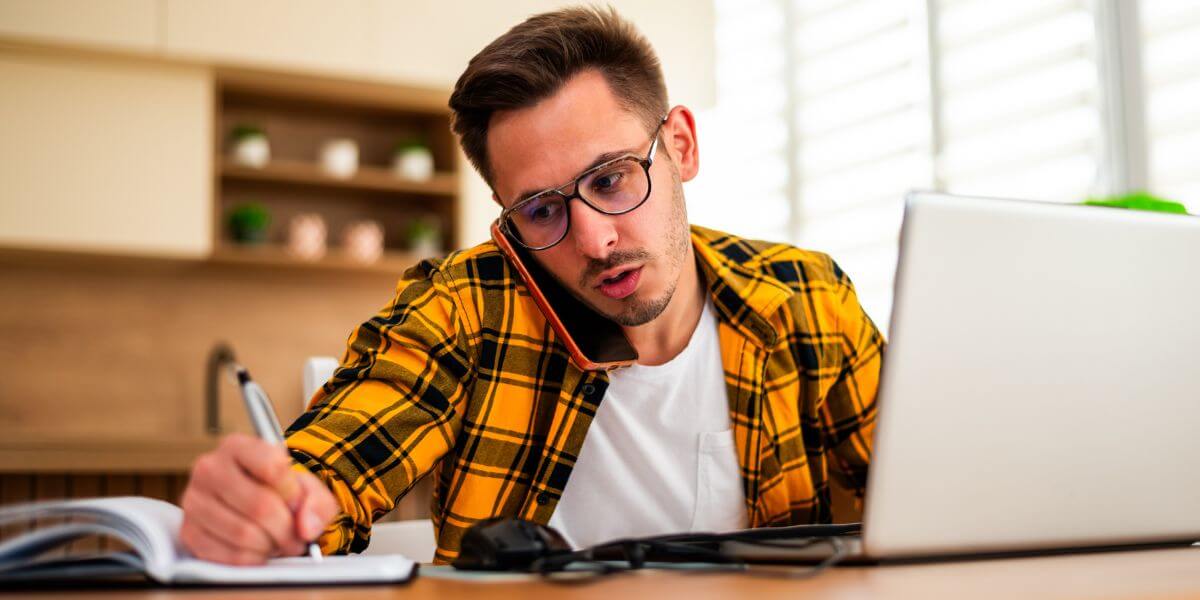 man on phone with laptop