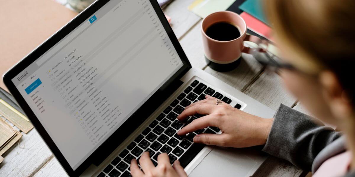 person checking email on laptop