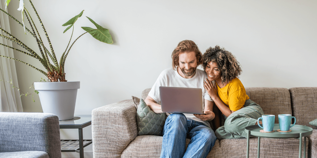 Couple using laptop in their apartment