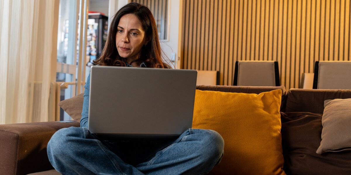 woman using laptop on couch