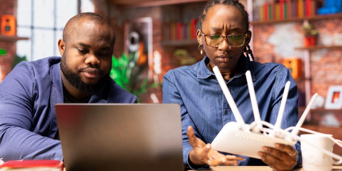 frustrated couple with router