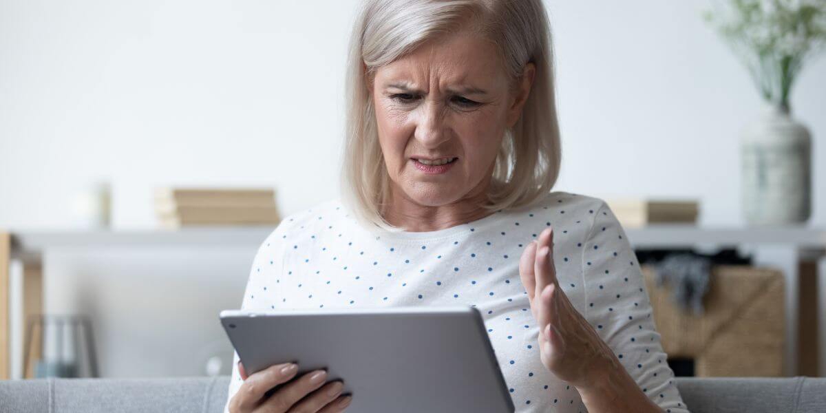 frustrated woman using tablet