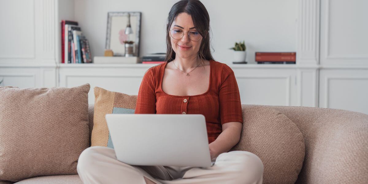 woman using laptop on couch