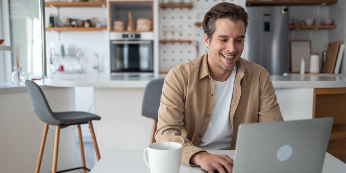 happy man using laptop
