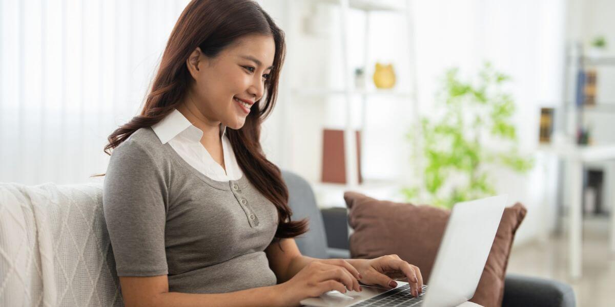 woman using tablet on couch