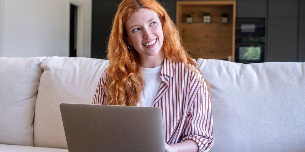 woman using tablet on couch