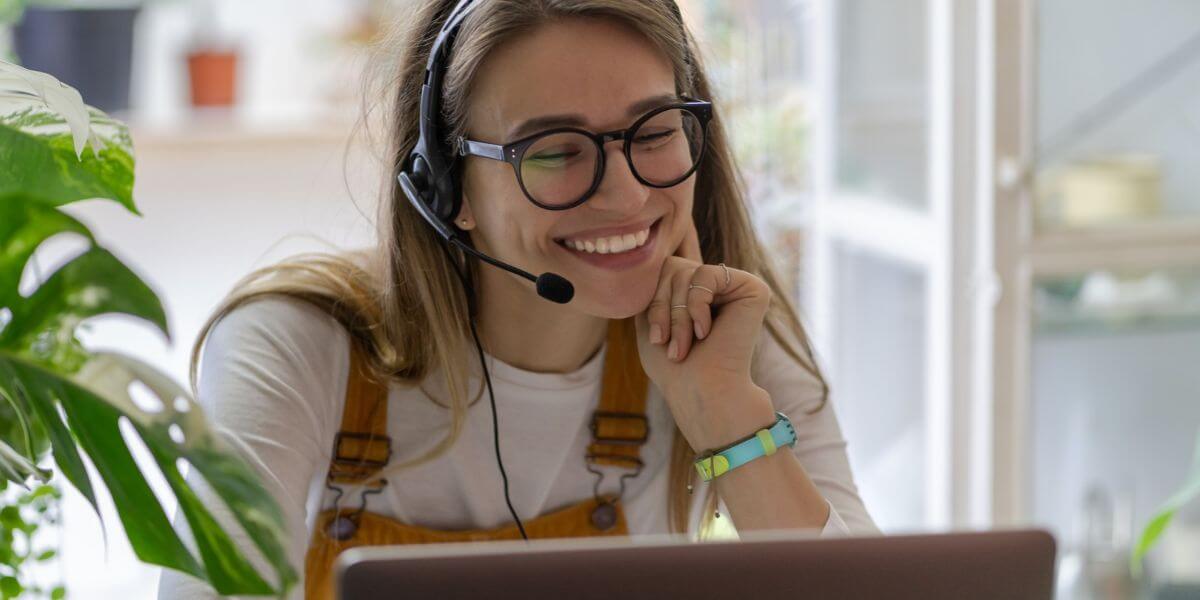 happy woman using headset and laptop