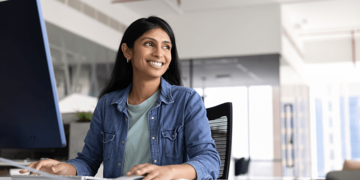 woman smiling while using computer