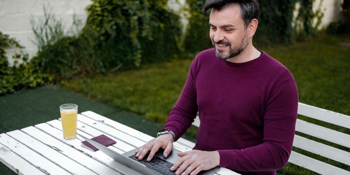 man using laptop at table