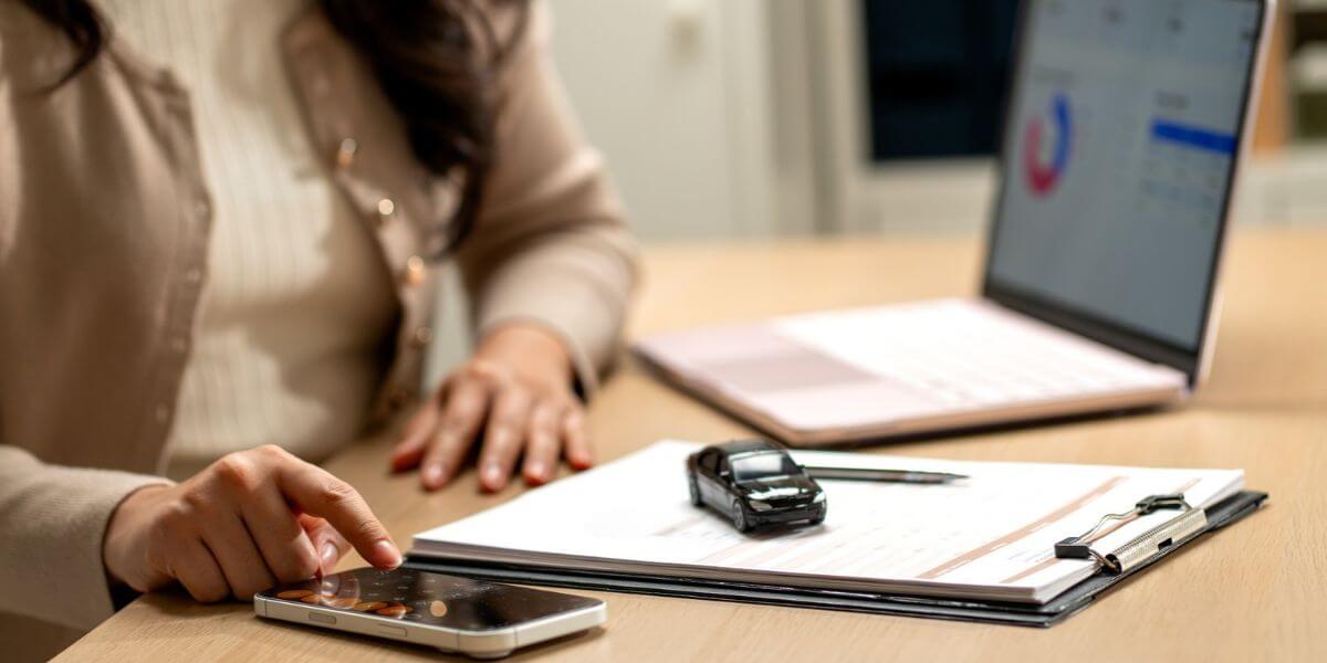 person at desk with phone and laptop