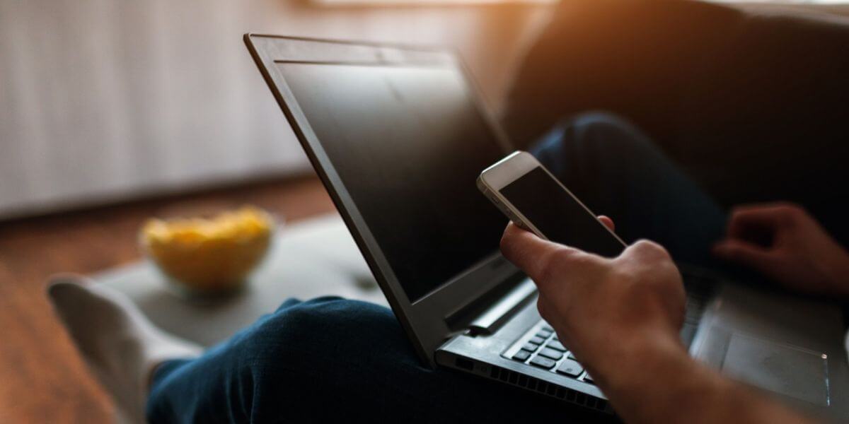 person using laptop and phone