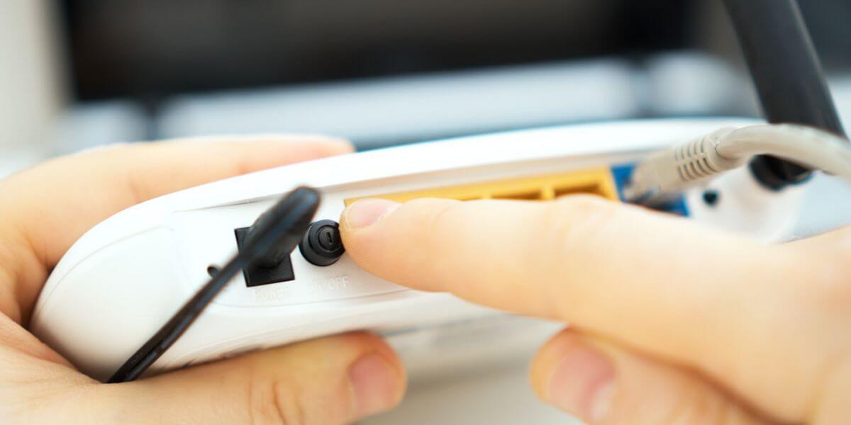 person resetting router