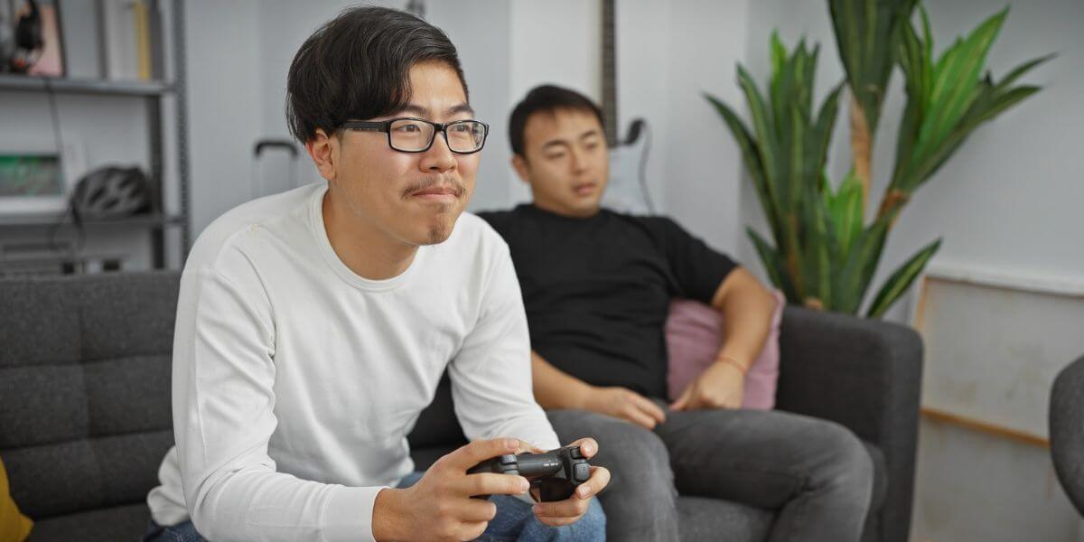 people playing video games on couch