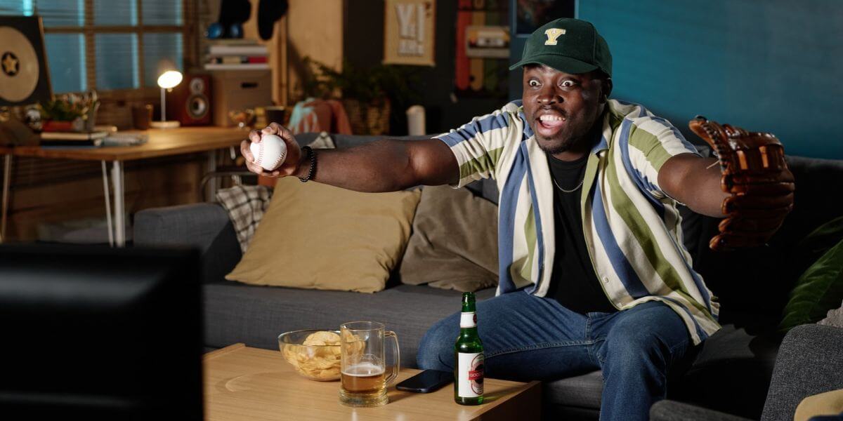 man watching baseball on tv