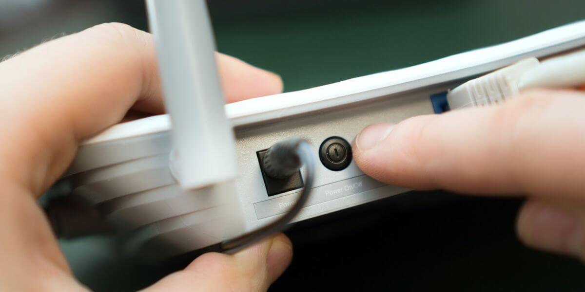 person resetting router